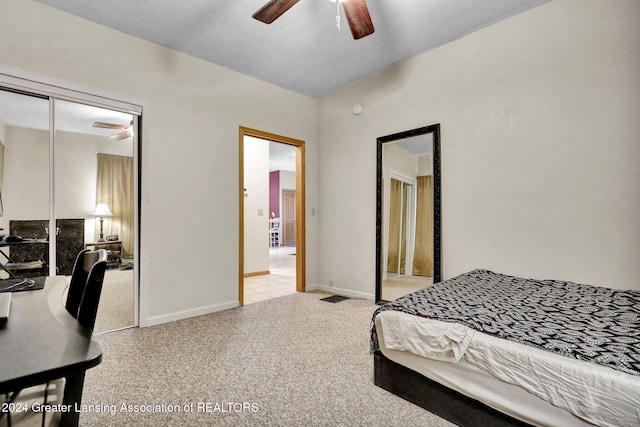 carpeted bedroom featuring a closet and ceiling fan