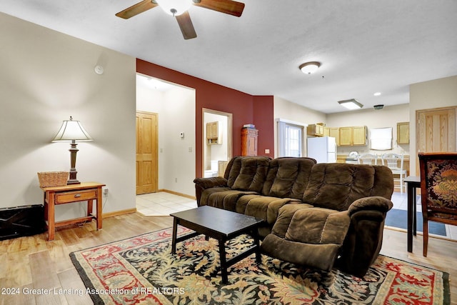 living room with ceiling fan and light hardwood / wood-style floors