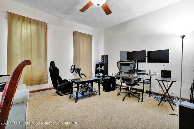 home office with ceiling fan, carpet floors, and a textured ceiling