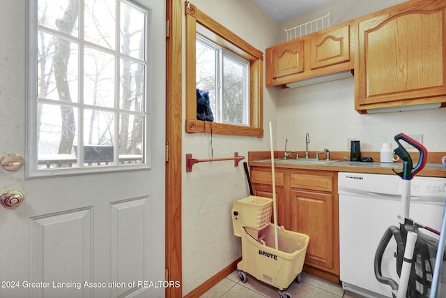 interior space featuring light tile patterned floors and sink