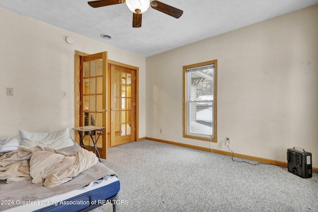 sitting room with carpet flooring, ceiling fan, and a textured ceiling