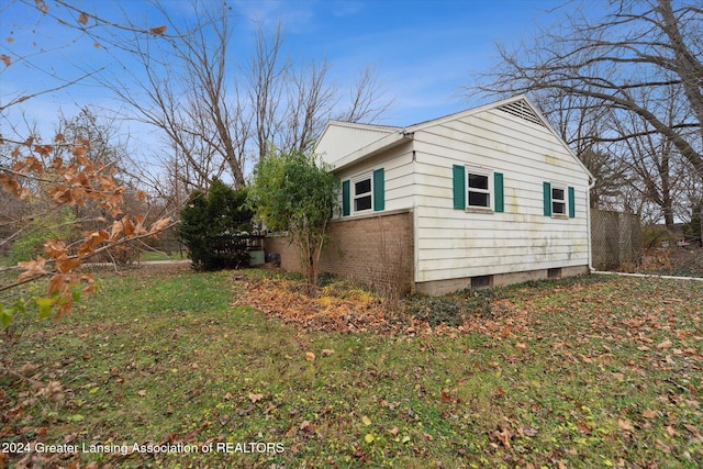 view of property exterior with a lawn