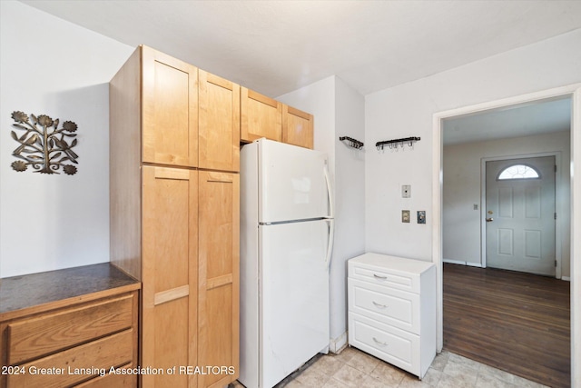 kitchen featuring white fridge, light brown cabinetry, and light hardwood / wood-style flooring