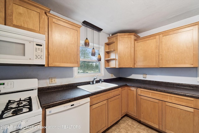 kitchen with light tile patterned floors, white appliances, sink, and hanging light fixtures