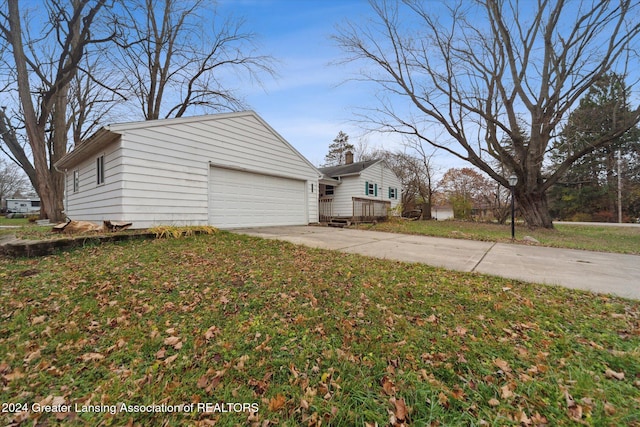 view of side of property featuring a lawn and a wooden deck