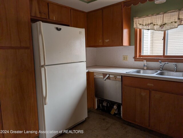 kitchen with dishwasher, sink, and white fridge