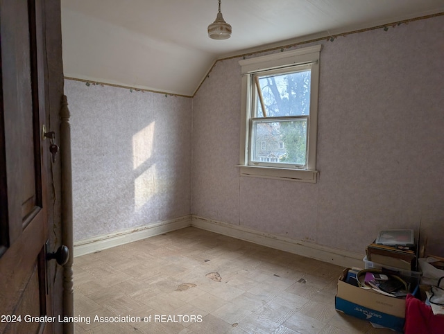 additional living space featuring lofted ceiling