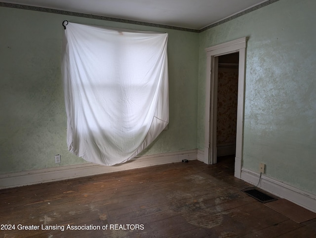 empty room with dark hardwood / wood-style flooring