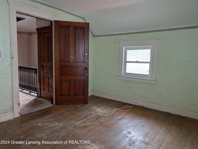 unfurnished bedroom featuring wood-type flooring and vaulted ceiling