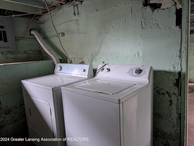 laundry room featuring electric panel and washer and dryer