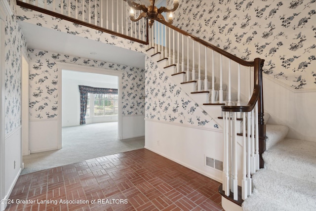 staircase featuring a chandelier