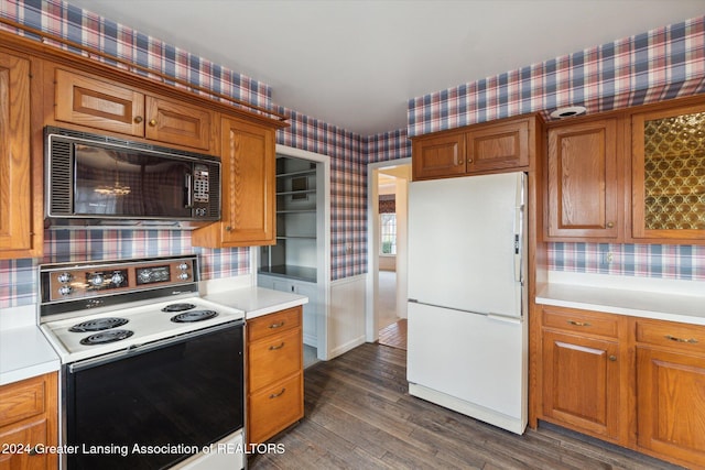 kitchen with backsplash, dark wood-type flooring, and white appliances