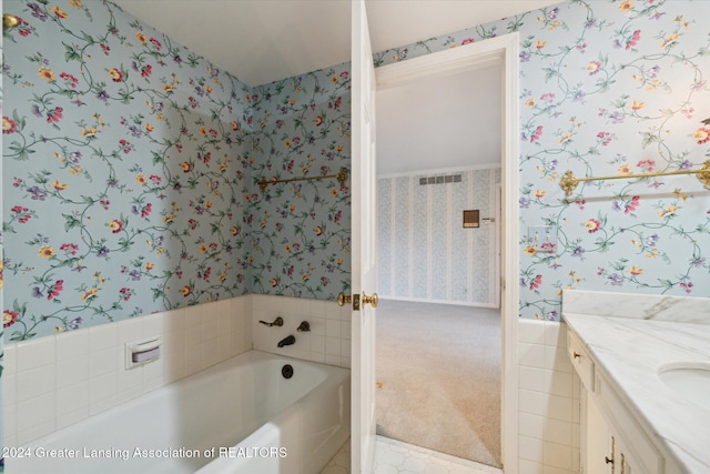 bathroom with vanity and a tub to relax in