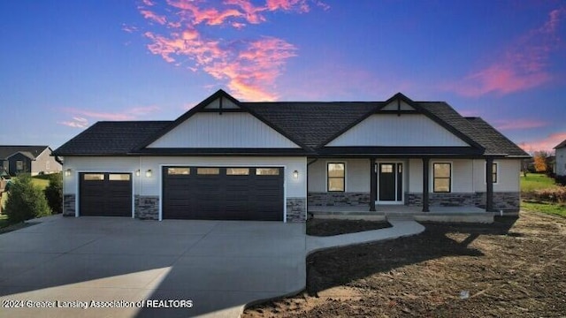 view of front of house featuring a porch and a garage