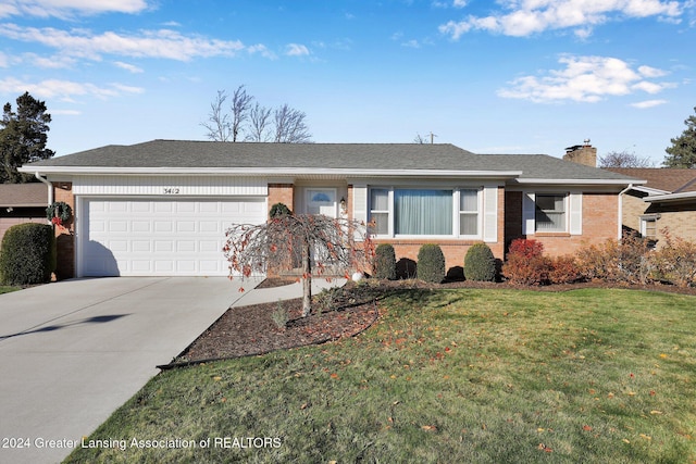 ranch-style house featuring a front yard and a garage