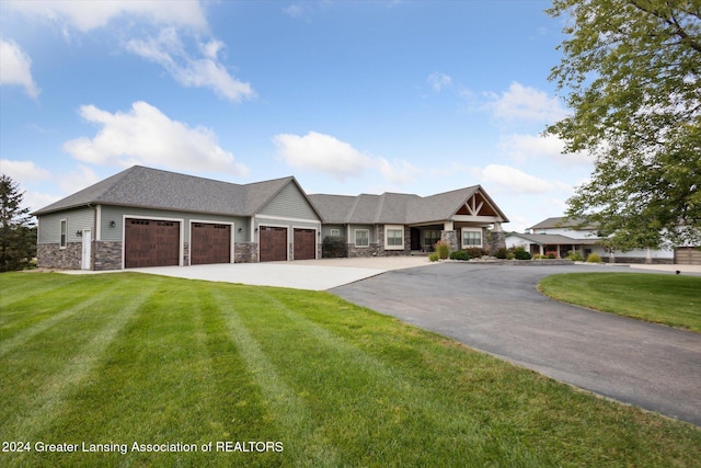 view of front of home with a garage and a front lawn