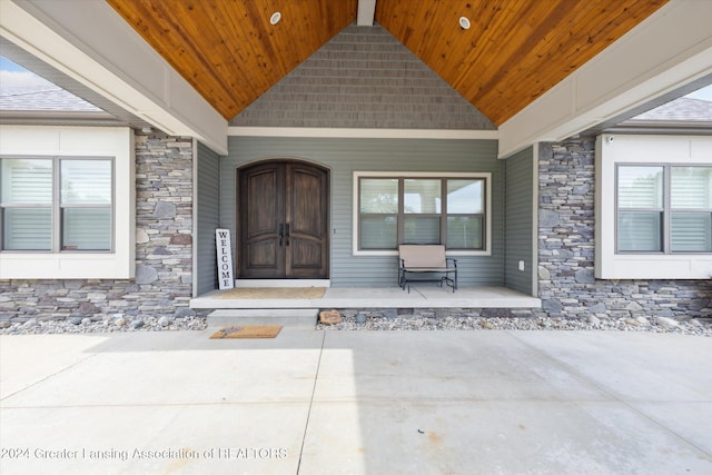 view of exterior entry with covered porch