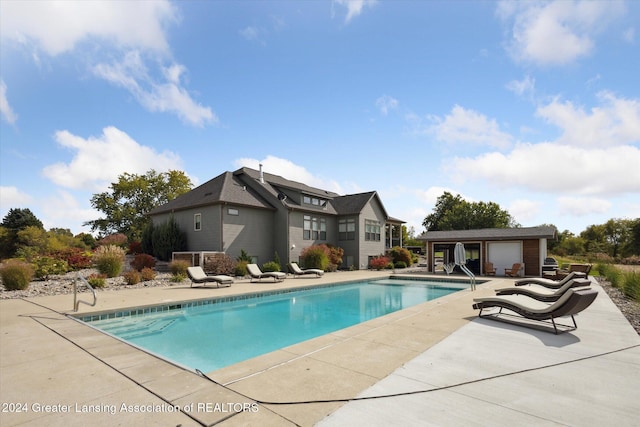 view of pool featuring a patio and an outdoor structure