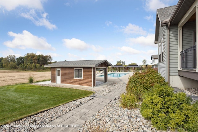 view of property exterior with an outdoor structure and a lawn