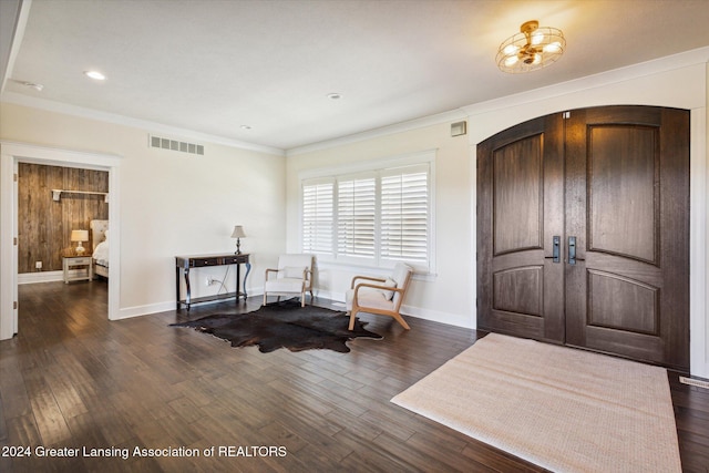 foyer with dark hardwood / wood-style flooring and ornamental molding