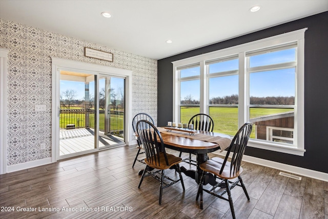 dining area featuring a healthy amount of sunlight and dark wood-type flooring