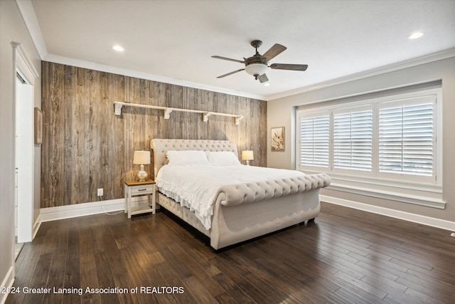 bedroom with dark hardwood / wood-style floors, wood walls, crown molding, and ceiling fan