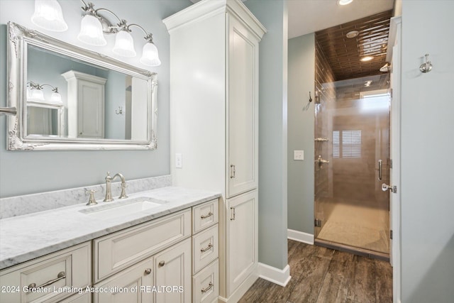 bathroom featuring vanity, hardwood / wood-style flooring, and a shower with shower door