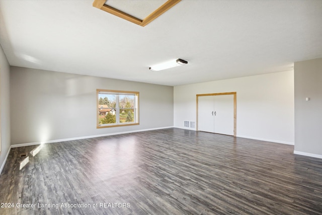 unfurnished room featuring dark wood-type flooring