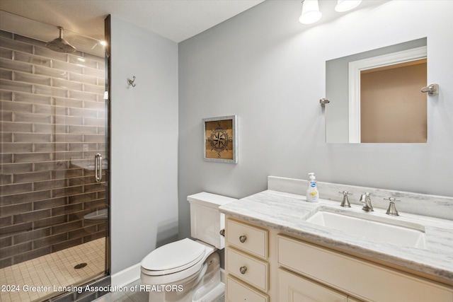 bathroom with vanity, toilet, and an enclosed shower