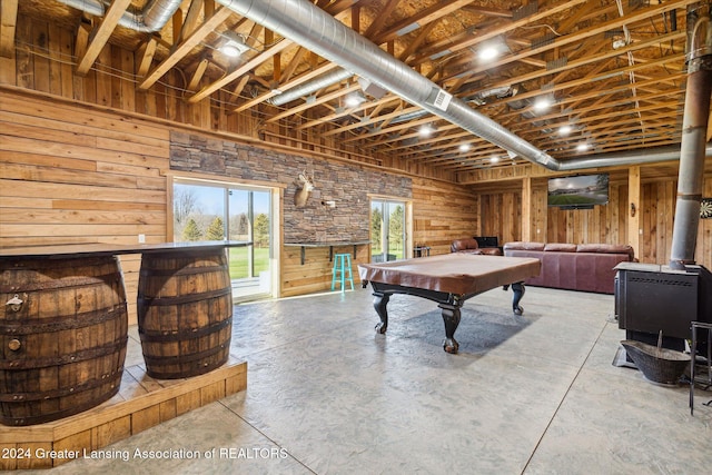 recreation room featuring wood walls, concrete flooring, and pool table