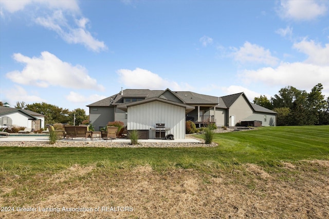 back of property with a lawn and a patio