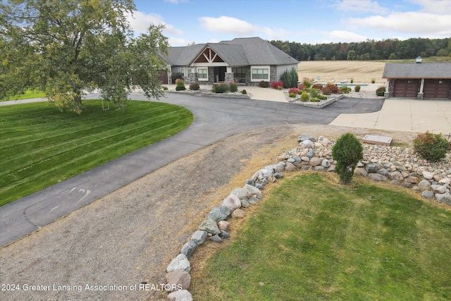 craftsman inspired home featuring a garage and a front yard