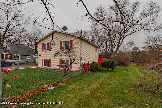 view of side of home featuring a yard