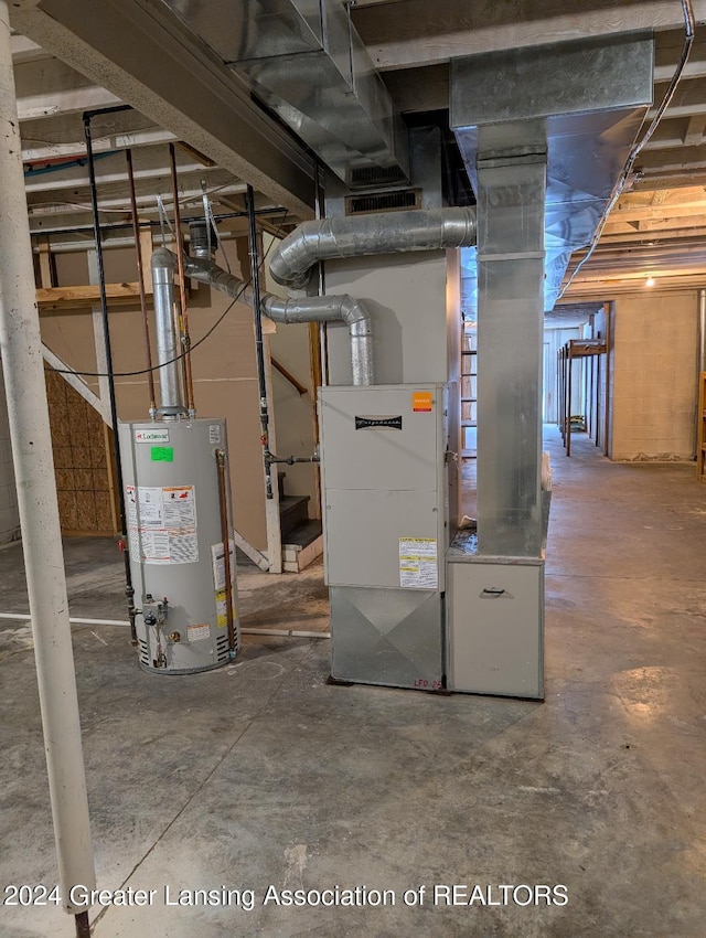 utility room featuring water heater