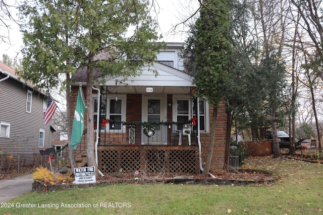 bungalow-style house with a front yard and a porch