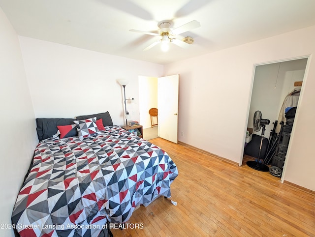 bedroom featuring ceiling fan, a closet, and light wood-type flooring