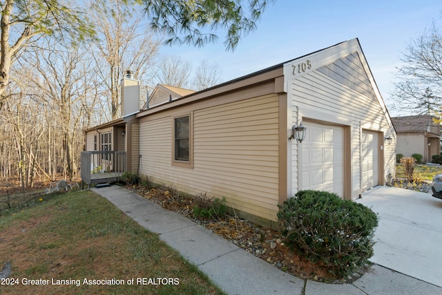 view of side of home featuring a garage