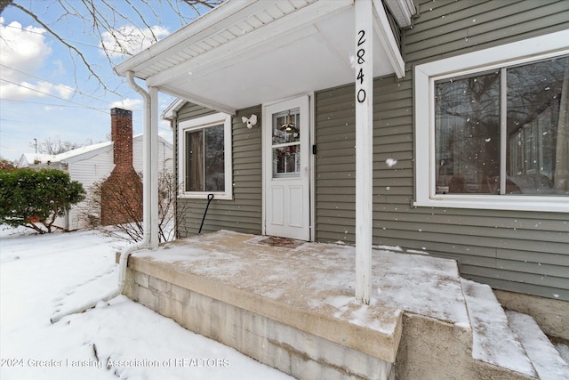 view of snow covered property entrance