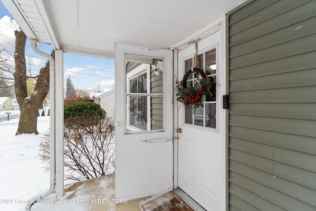 view of snow covered property entrance