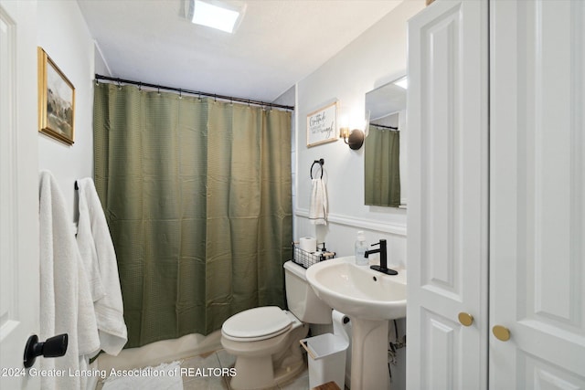 bathroom featuring toilet, tile patterned floors, and walk in shower