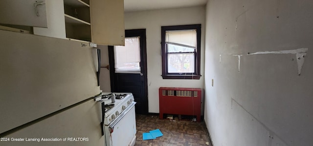 kitchen featuring white appliances and radiator