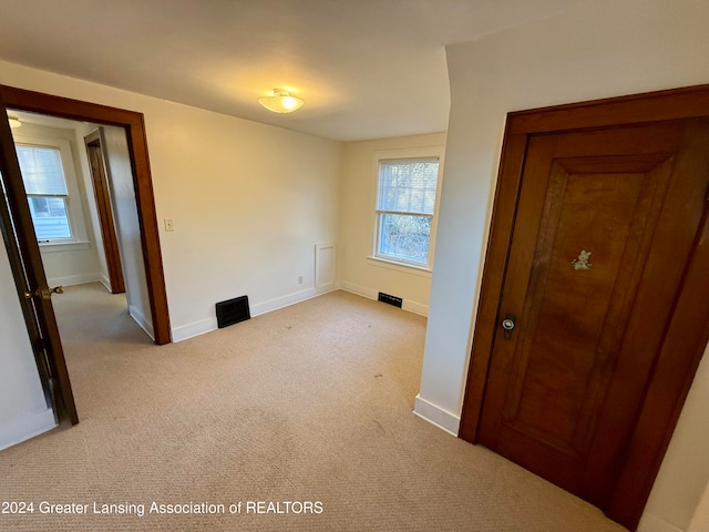 empty room featuring light carpet