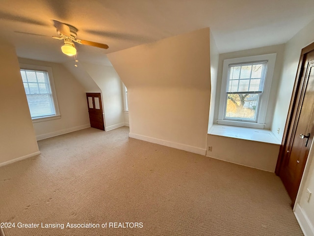 bonus room with light carpet, ceiling fan, and lofted ceiling