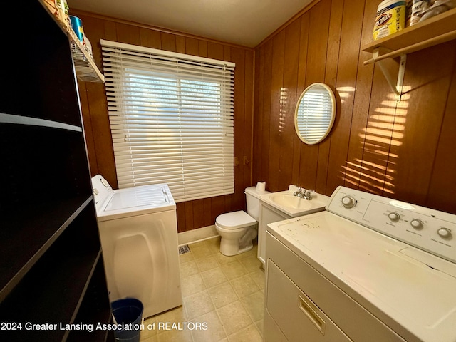 laundry room with wood walls and sink