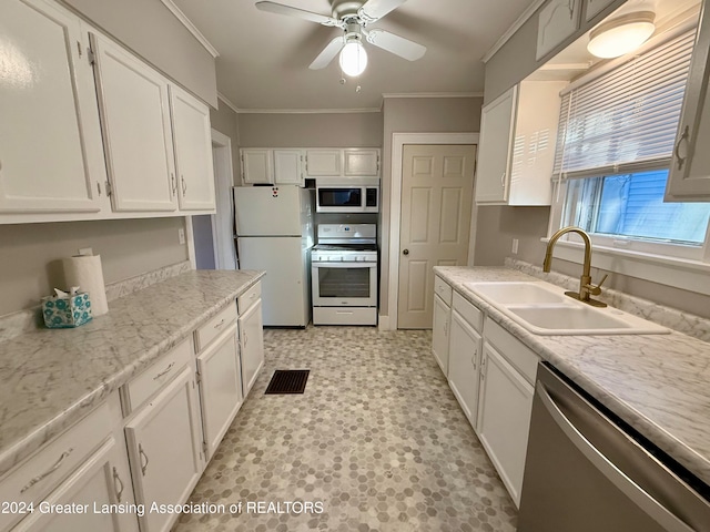 kitchen featuring ceiling fan, sink, crown molding, white appliances, and white cabinets