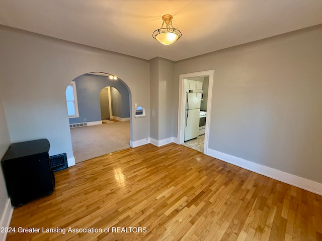 spare room with light hardwood / wood-style floors