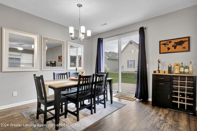 dining area featuring an inviting chandelier, baseboards, dark wood finished floors, and visible vents