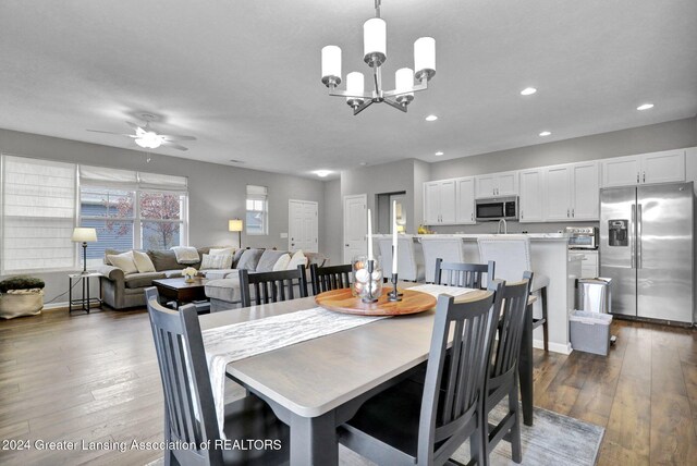 dining area featuring a toaster, baseboards, dark wood-style floors, recessed lighting, and ceiling fan with notable chandelier