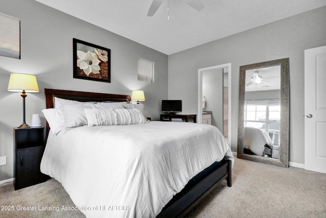 bedroom featuring baseboards, light carpet, ceiling fan, and ensuite bathroom