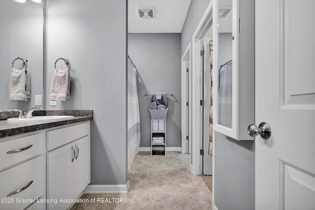 bathroom featuring vanity and baseboards